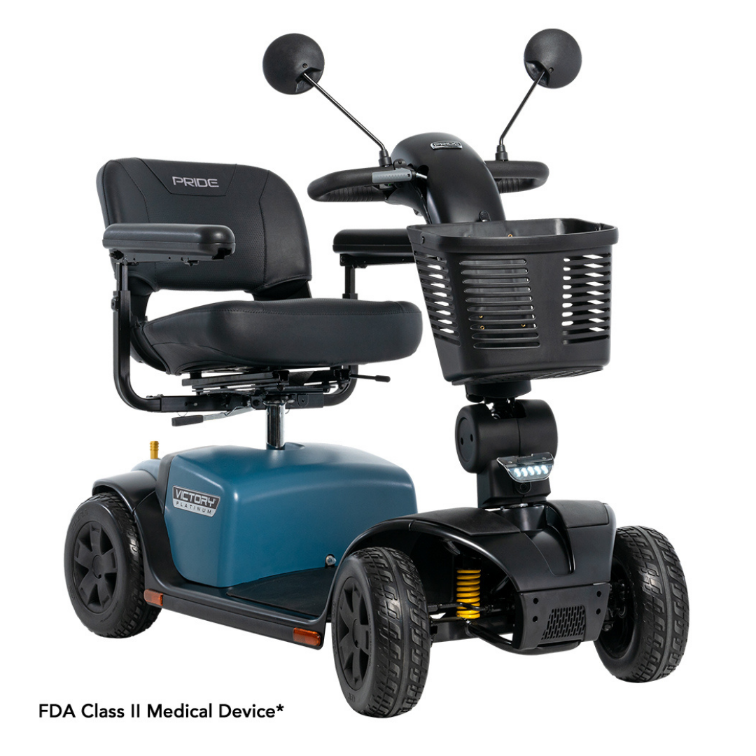 The Pride Mobility Victory® Platinum Bariatric 4-Wheel Scooter features EZ Turn technology, a black seat with armrests, blue base, front basket, and side mirrors. FDA Class II Medical Device* text appears in the corner.